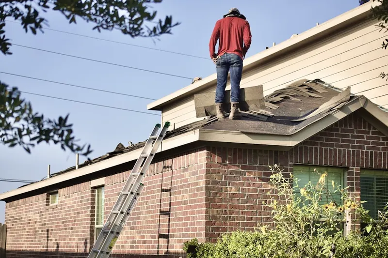 Professional roofer working on a residential roof in South Quincy